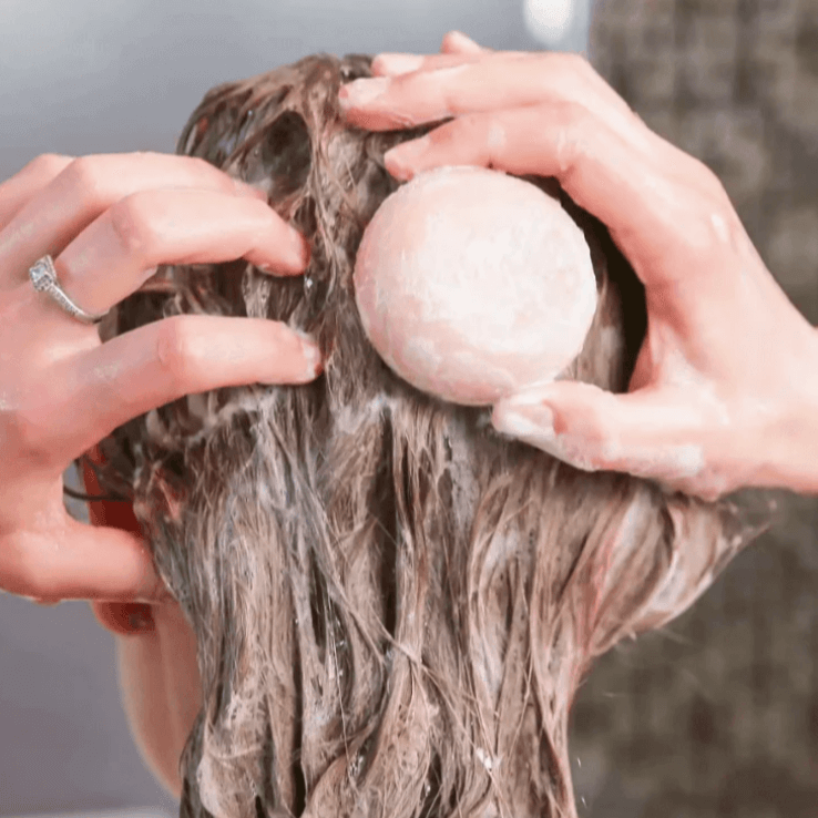 Applying solid shampoo for dry hair to nourish and hydrate with natural ingredients, sulfate-free clean beauty.