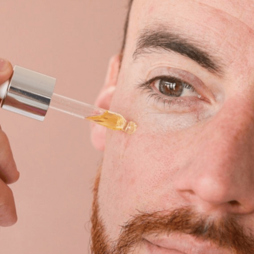 Man applying an anti-blemish serum for clean beauty and sensitive skin care routine.