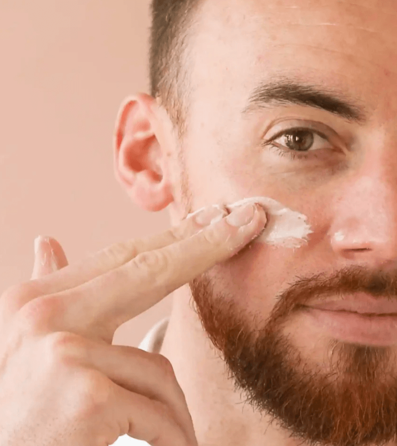 Man applying creamy skincare routine for radiant skin with natural ingredients for clean beauty.