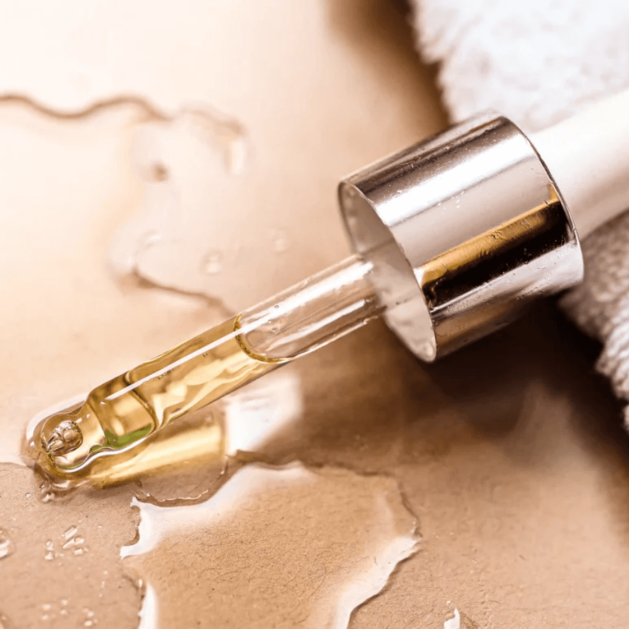 Close-up of a dropper with anti-blemish serum on a clean surface. Ideal for natural skincare and purifying care.